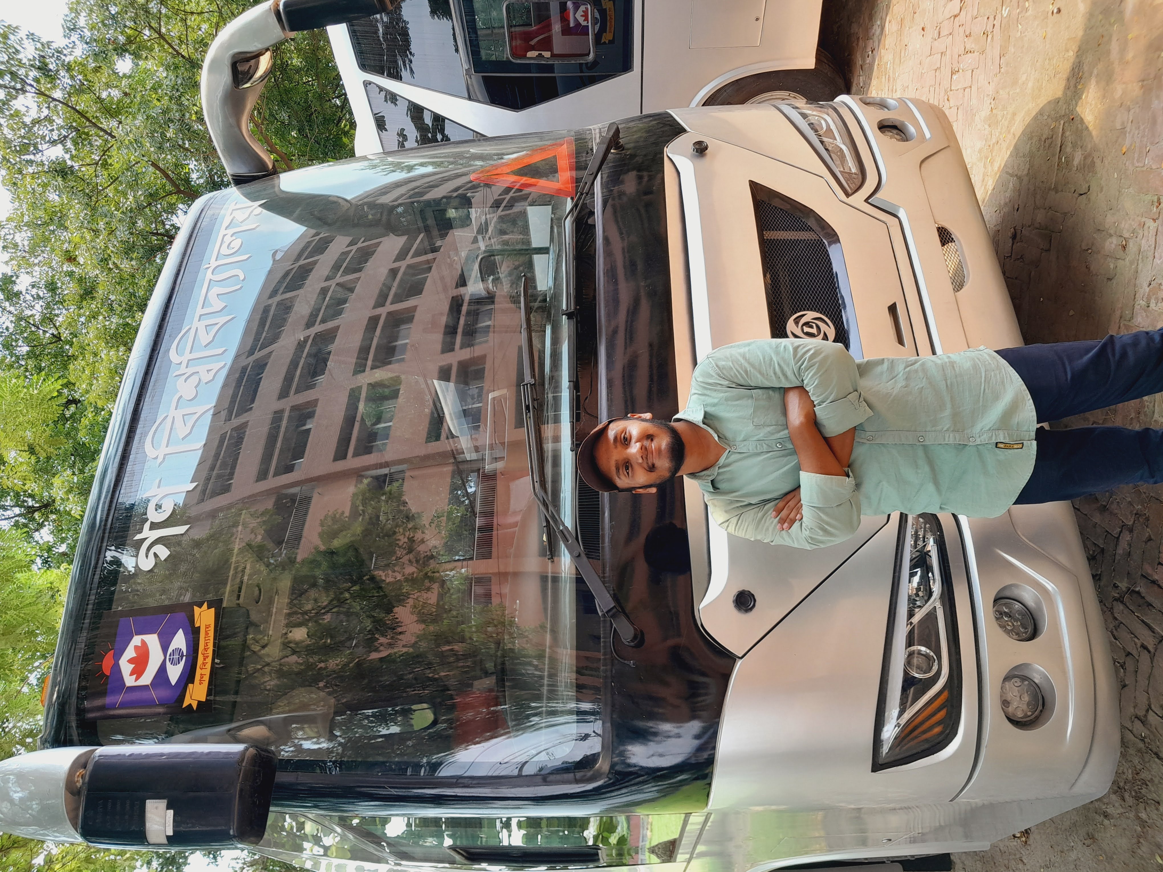 Md Maruf Hossen in front of the Gono University bus